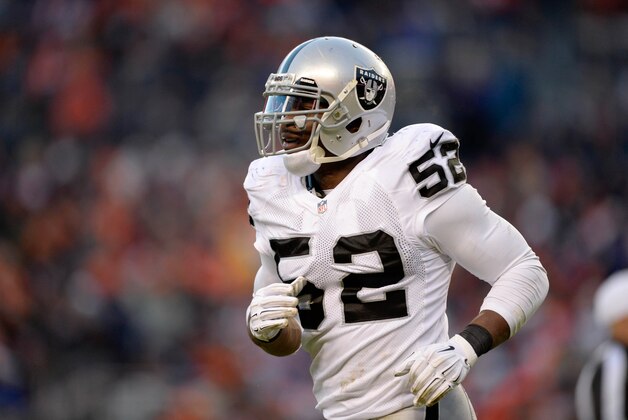Dec 28, 2014; Denver, CO, USA; Oakland Raiders outside linebacker Khalil Mack (52) leaves the field against the Denver Broncos in the third quarter at Sports Authority Field at Mile High. The Broncos defeated the Raiders 47-14. Mandatory Credit: Ron Chenoy-USA TODAY Sports