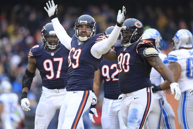 CHICAGO, IL - DECEMBER 21: Willie Young #97 of the Chicago Bears  and Jeremiah Ratliff #90 with Jared Allen #69 celebrates after he sacked Matthew Stafford #9 of the Detroit Lions during the first quarter at Soldier Field on December 21, 2014 in Chicago, Illinois. (Photo by Jamie Squire/Getty Images)