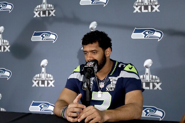 Seattle Seahawks' Russell Wilson waits for a question during an interview for NFL Super Bowl XLIX football game, Thursday, Jan. 29, 2015, in Phoenix. The Seahawks play the New England Patriots in Super Bowl XLIX on Sunday, Feb. 1, 2015. (AP Photo/Matt York)
