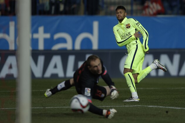 Barcelona's Neymar, scores his goal as Atletico's Jan Oblak, tries to make a save during a Copa del Rey Quarterfinal soccer match between Atletico de Madrid and FC Barcelona at the Vicente Calderon stadium in Madrid, Spain, Wednesday, Jan. 28, 2015. (AP Photo/Andres Kudacki)