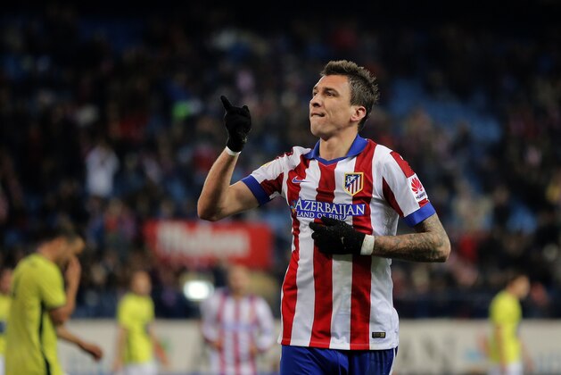 Atletico's Mario Mandzukic celebrates after scoring a goal during a King’s Cup soccer match between Atletico de Madrid and Hospitalet at the Vicente Calderon stadium in Madrid, Spain, Thursday, Dec. 18, 2014. (AP Photo/Daniel Ochoa de Olza)