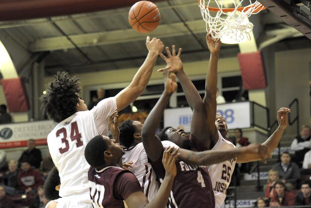 Jan 14, 2015; Philadelphia, PA, USA; Saint Joseph's Hawks forward Javon Baumann (34), guard Chris Wilson (24) and forward James Demery (25) battle with Fordham Rams forward Ryan Rhoomes (30) and guard Eric Paschall (4) for rebound during the first half at Hagan Arena. Mandatory Credit: Eric Hartline-USA TODAY Sports