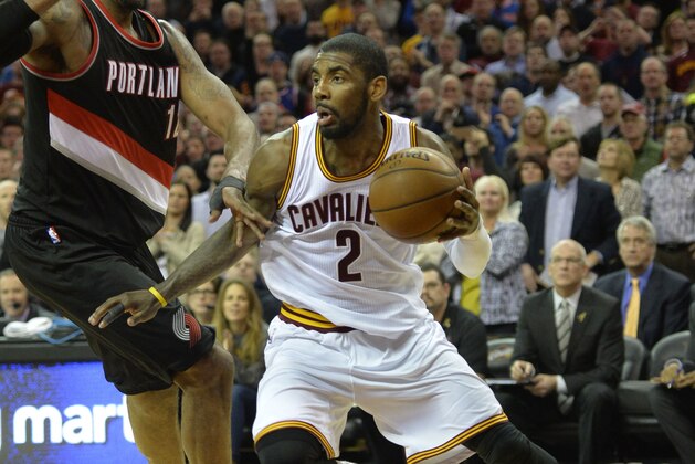 Jan 28, 2015; Cleveland, OH, USA; Cleveland Cavaliers guard Kyrie Irving (2) drives against Portland Trail Blazers forward LaMarcus Aldridge (12) in the fourth quarter at Quicken Loans Arena. Mandatory Credit: David Richard-USA TODAY Sports