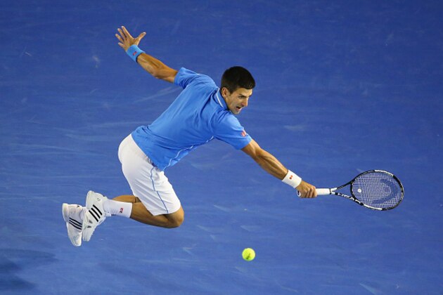 MELBOURNE, AUSTRALIA - JANUARY 28:  Novak Djokovic of Serbia stretches for a backhand in his quarter final match against Milos Raonic of Canada during day 10 of the 2015 Australian Open at Melbourne Park on January 28, 2015 in Melbourne, Australia.  (Photo by Scott Barbour/Getty Images)