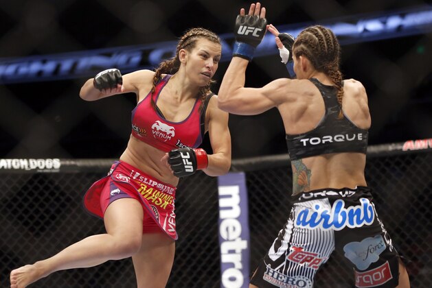 Miesha Tate, left, and Liz Carmouche fight in a mixed martial arts event on Saturday, April 19, 2014, at UFC Fight Night in Orlando Fla. Tate defeated Carmouche. (AP Photo/Reinhold Matay)