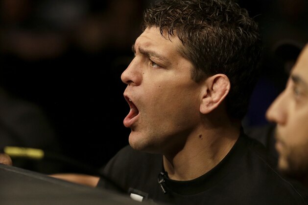 Nick Diaz, left, cheers on his brother Nate Diaz during a UFC lightweight mixed martial arts fight between Nate Diaz and Josh Thomson in San Jose, Calif., Saturday, April 20, 2013. Thomson won by technical knock out in the second round. (AP Photo/Jeff Chiu)