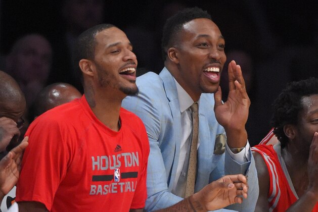 Houston Rockets' Trevor Ariza, left, Dwight Howard, center, and Patrick Beverley yell toward the the players on the court during the second half of an NBA basketball game Los Angeles Lakers, Sunday, Jan. 25, 2015, in Los Angeles.   The Houston won 99-87. (AP Photo/Mark J. Terrill)