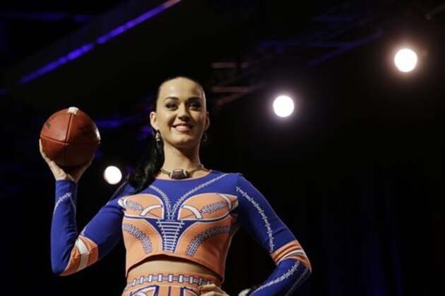 Katy Perry poses with a football at a news conference regarding the half time show for NFL Super Bowl XLIX football game Thursday, Jan. 29, 2015, in Phoenix. (AP Photo/David J. Phillip)