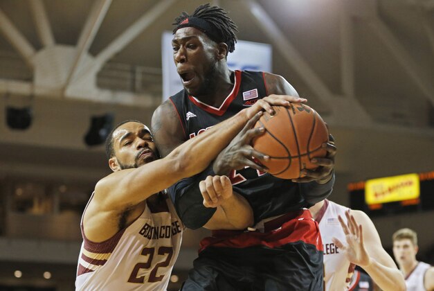 Jan 28, 2015; Chestnut Hill, MA, USA; Louisville Cardinals forward Montrezl Harrell (24) pulls down a rebound in front of Boston College Eagles guard Aaron Brown (22) during the second half at Silvio O. Conte Forum. Louisville Cardinals won 81-72.  Mandatory Credit: Greg M. Cooper-USA TODAY Sports