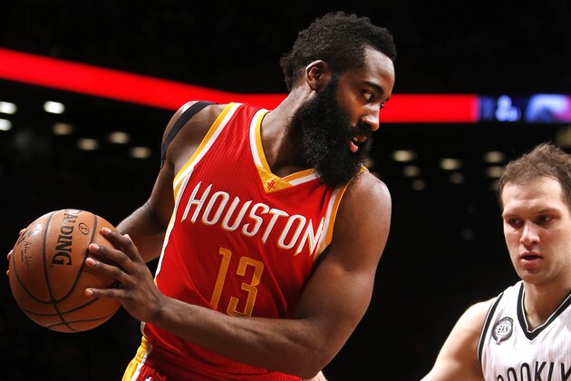 Houston Rockets' James Harden (13) controls the ball against Brooklyn Nets' Bojan Bogdanovic (44), of Croatia, during the first quarter of an NBA basketball game Monday, Jan. 12, 2015, in New York.  Houston beat Brooklyn 113-99. (AP Photo/Jason DeCrow)