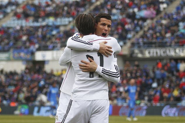 Real Madrid's Gareth Bale, left, celebrates his goal with Real Madrid's Cristiano Ronaldo, right, during a Spanish La Liga soccer match between Getafe and Real Madrid at the Coliseum Alfonso Perez stadium in Madrid, Spain, Sunday, Jan. 18, 2015. (AP Photo/Andres Kudacki)