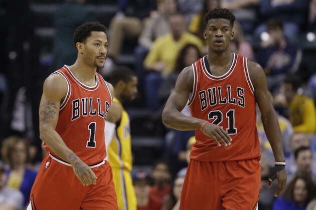 Chicago Bulls' Derrick Rose (1) and Jimmy Butler (21) talk during the first half of an NBA basketball game against the Indiana Pacers Monday, Dec. 29, 2014, in Indianapolis. (AP Photo/Darron Cummings)