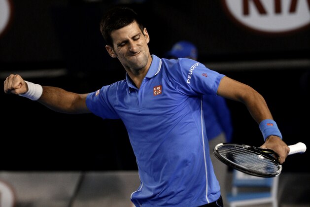 Novak Djokovic of Serbia celebrates the match point after defeating Stan Wawrinka of Switzerland in their semifinal match at the Australian Open tennis championship in Melbourne, Australia, Friday, Jan. 30, 2015. (AP Photo/Bernat Armangue)