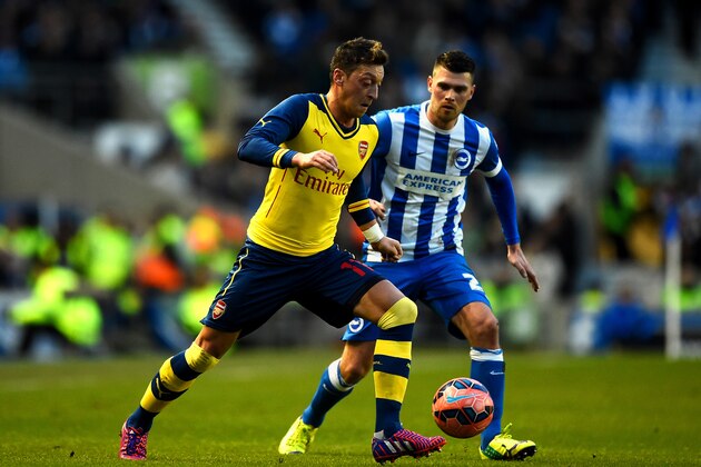 BRIGHTON, ENGLAND - JANUARY 25:  Mesut Oezil of Arsenal battles for the ball with Danny Holla of Brighton during the FA Cup Fourth Round match between Brighton & Hove Albion and Arsenal at Amex Stadium on January 25, 2015 in Brighton, England.  (Photo by Mike Hewitt/Getty Images)