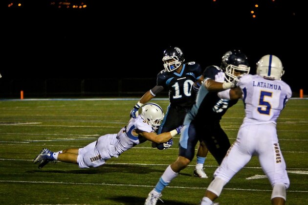 Jerome Heavens, Notre Dame fullback, slips after making a seven year gain in the first quarter of the Cotton Bowl game against the University of Texas on Monday, Jan. 2,1978 in Dallas. Coming in to make sure Heavens is down are Ricky Churchman and Johnnie Johnson. (AP Photo)