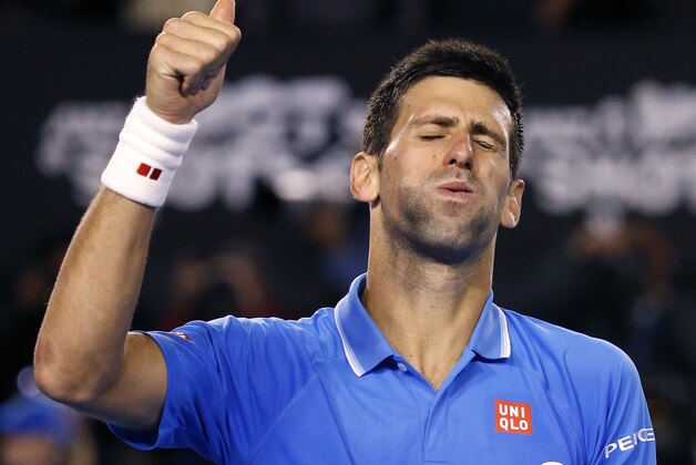Novak Djokovic of Serbia celebrates after defeating Stan Wawrinka of Switzerland in their semifinal at the Australian Open tennis championship in Melbourne, Australia, Friday, Jan. 30, 2015. (AP Photo/Vincent Thian)