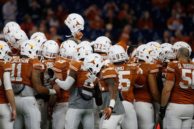 HOUSTON, TX - DECEMBER 29:  Members of the Texas Longhorns huddle on the field before the start of their game against the Arkansas Razorbacks at the AdvoCare V100 Texas Bowl at NRG Stadium on December 29, 2014 in Houston, Texas.  (Photo by Scott Halleran/Getty Images)