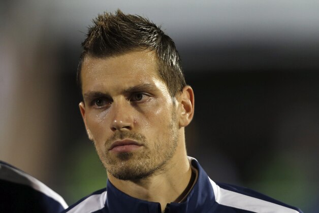 France's Morgan Schneiderlin stands during the playing of his country's national anthem before the start of their international friendly soccer match against Serbia, in Belgrade, Serbia, Sunday, Sept. 7, 2014. (AP Photo/Darko Vojinovic)