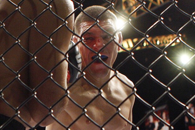 Nick Diaz, right, throws a punch at BJ Penn during a mixed martial arts welterweight bout, Saturday, Oct. 29, 2011, in Las Vegas. Diaz won by unanimous decision. (AP Photo/Isaac Brekken)