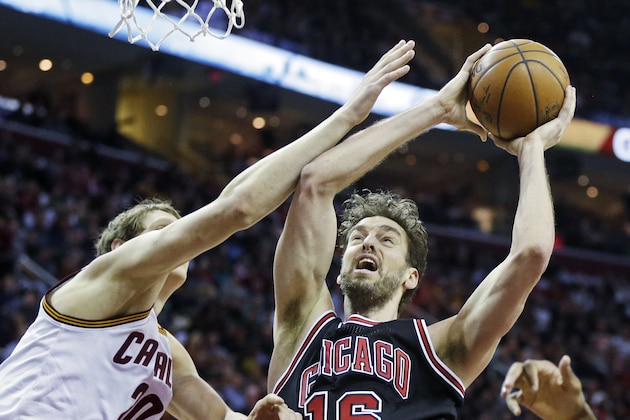 Chicago Bulls' Pau Gasol (16), from Spain, shoots against Cleveland Cavaliers' Timofey Mozgov, from Russia, in the second quarter of an NBA basketball game Monday, Jan. 19, 2015, in Cleveland. (AP Photo/Mark Duncan)