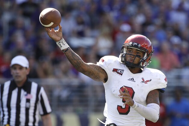 FILE - In this Sept. 6, 2014, file photo, Eastern Washington quarterback Vernon Adams Jr. throws a pass against Washington Huskies in the second half of an NCAA college football game  in Seattle. Eastern Washington's record-setting quarterback says he has received a scholarship offer from Oregon and will visit the school this weekend. Adams told The Spokesman-Review on Wednesday, Jan. 28, 2015, that he will fly to Eugene, Oregon, on Friday and return Sunday.  (AP Photo/Elaine Thompson, File)