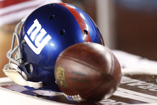 Sep 25, 2014; Landover, MD, USA; A New York Giants player's helmet rests with a game ball on the sidelines against the Washington Redskins at FedEx Field. Mandatory Credit: Geoff Burke-USA TODAY Sports