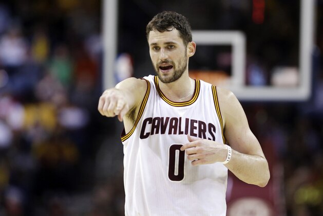 FILE - In this Jan. 28, 2015, file photo, Cleveland Cavaliers' Kevin Love talks with a teammate during an NBA basketball game against the Portland Trail Blazers in Cleveland. The surging Cleveland Cavaliers visit Minnesota on Saturday for the first time since they acquired Kevin Love from the Timberwolves in the summer blockbuster deal.  (AP Photo/Tony Dejak, File)