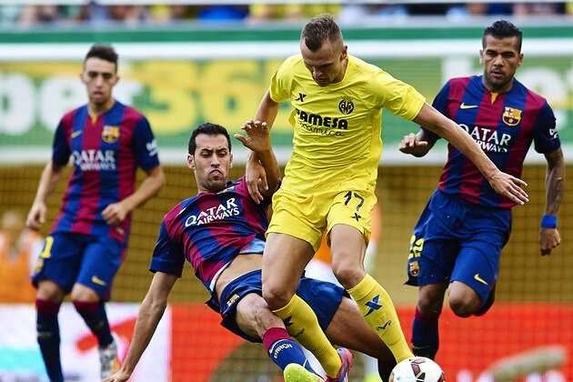 VILLARREAL, SPAIN - AUGUST 31:  Denis Cheryshev of Villarreal is tackled by Sergio Busquets of Barcelona during the La Liga match between Villarreal CF and FC Barcelona at El Madrigal stadium on August 31, 2014 in Villarreal, Spain.  (Photo by Manuel Queimadelos Alonso/Getty Images)