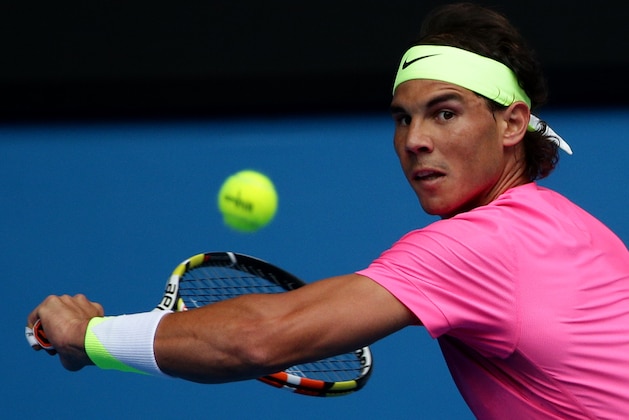 Rafael Nadal of Spain makes a return to Tomas Berdych of the Czech Republic  during their quarterfinal match at the Australian Open tennis championship in Melbourne, Australia, Tuesday, Jan. 27, 2015. (AP Photo/Rob Griffith)