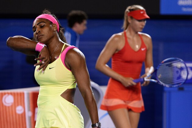 Serena Williams of the U.S., left, and  Maria Sharapova of Russia change ends  during the women's singles final at the Australian Open tennis championship in Melbourne, Australia, Saturday, Jan. 31, 2015. (AP Photo/Rob Griffith)