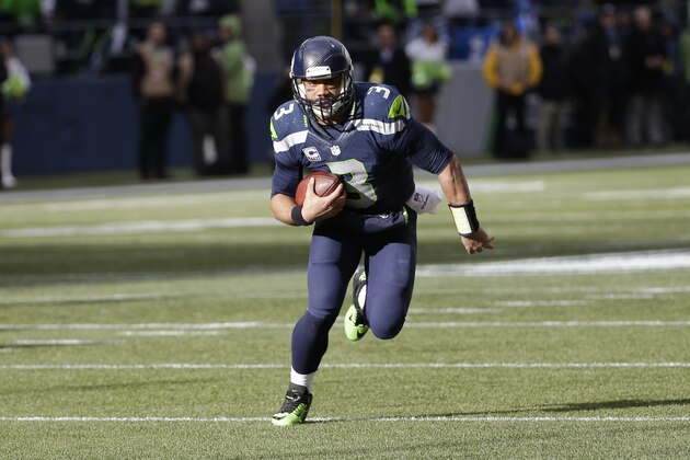 Seattle Seahawks quarterback Russell Wilson (3) runs against the Green Bay Packers during the first half of the NFL football NFC Championship game Sunday, Jan. 18, 2015, in Seattle. (AP Photo/David J. Phillip)