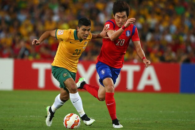 SYDNEY, AUSTRALIA - JANUARY 31: Massimo Luongo of Australia is chased by Jang Hyunsoo of Korea Republic during the 2015 Asian Cup final match between Korea Republic and the Australian Socceroos at ANZ Stadium on January 31, 2015 in Sydney, Australia.  (Photo by Robert Cianflone/Getty Images)