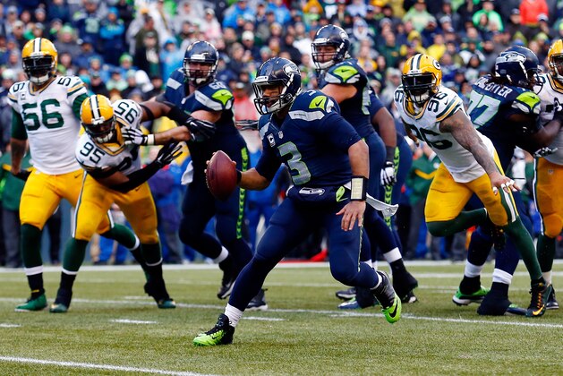 SEATTLE, WA - JANUARY 18: Russell Wilson #3 of the Seattle Seahawks runs the ball in for a touchdown during the fourth quarter of the 2015 NFC Championship game against the Green Bay Packers at CenturyLink Field on January 18, 2015 in Seattle, Washington.  (Photo by Tom Pennington/Getty Images)