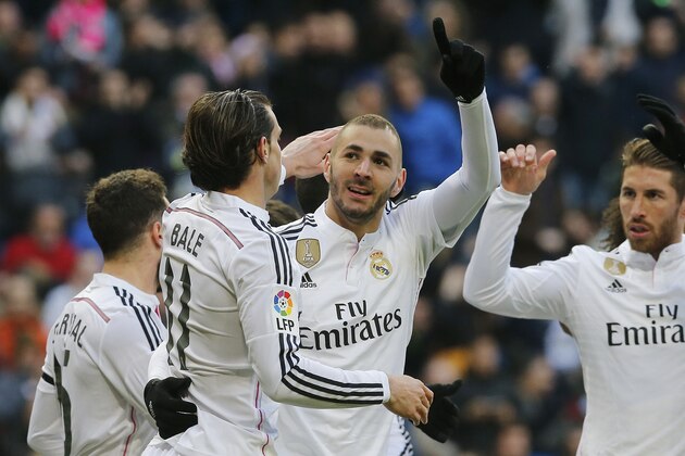 Real Madrid's Karim Benzema, center, celebrates after he scored during a Spanish La Liga soccer match between Real Madrid and Real Sociedad at the Santiago Bernabeu stadium in Madrid, Spain, Saturday Jan. 31, 2015. (AP Photo/Paul White)