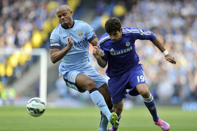 Manchester City's Vincent Kompany left, and Chelsea's Diego Costa battle for the ball during their English Premier League soccer match at the Etihad Stadium in Manchester, England, Sunday Sept. 21, 2014. (AP Photo/Clint Hughes)