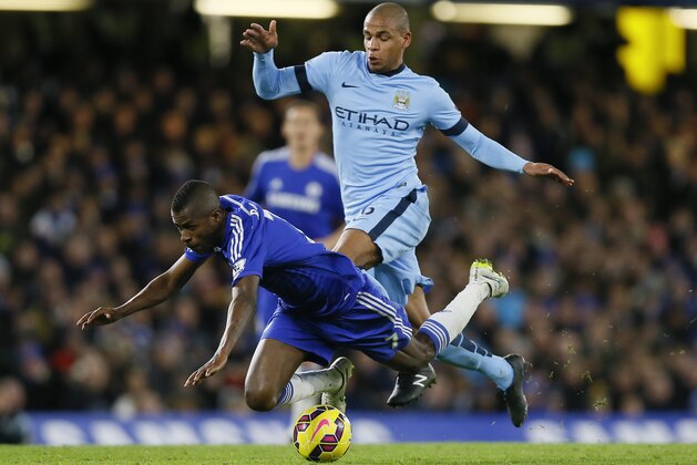 Chelsea's Ramires, left, falls as he vies for the ball with Manchester City's Fernando during the English Premier League soccer match between Chelsea and Manchester City at Stamford Bridge stadium in London, Saturday, Jan. 31, 2015. (AP Photo/Kirsty Wigglesworth)