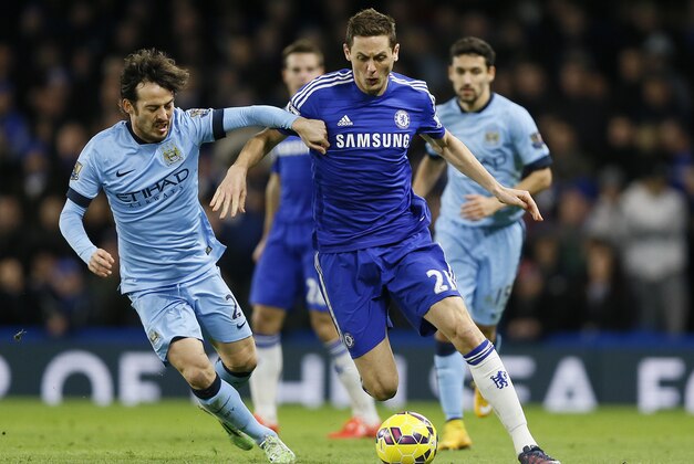 Chelsea's Nemanja Matic, right, competes for the ball with Manchester City's  David Silva during the English Premier League soccer match between Chelsea and Manchester City at Stamford Bridge stadium in London, Saturday, Jan. 31, 2015. (AP Photo/Kirsty Wigglesworth)