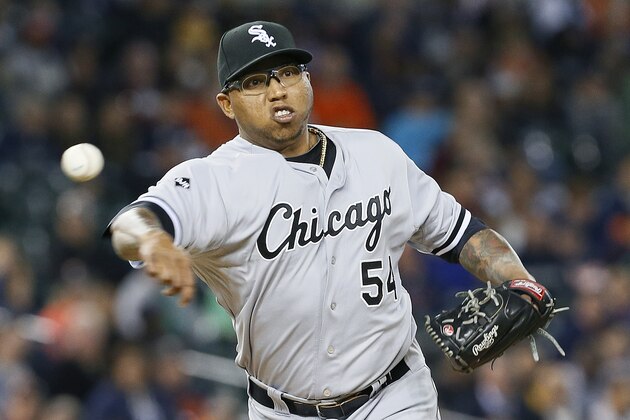 Chicago White Sox relief pitcher Ronald Belisario throws to first base against the Detroit Tigers in the seventh inning of a baseball game in Detroit Tuesday, Sept. 23, 2014. (AP Photo/Paul Sancya)