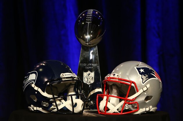 PHOENIX, AZ - JANUARY 30:  The Vince Lombardi Trophy is displayed between the helmets of the Seattle Seahawks (L) and New England Patriots prior to a joint press conference with Head Coach Bill Belichick of the New England Patriots and Head Coach Pete Carroll of the Seattle Seahawks prior to the upcoming Super Bowl XLIX on January 30, 2015 in Phoenix, Arizona.  (Photo by Mike Lawrie/Getty Images)