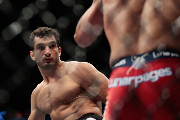 Iranian born Gegard Mousasi, right, fights Mark Munoz from the United States in a middleweight fight during the UFC Fight Night mixed martial arts event in Berlin, Saturday, May 31, 2014.  Gegard Mousasi won the fight. (AP Photo/Markus Schreiber)