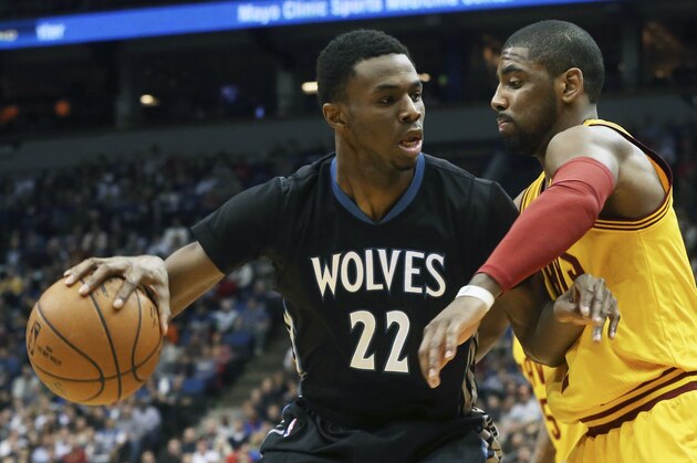 Minnesota Timberwolves’ Andrew Wiggins, left, keeps the ball at arm's length from Cleveland Cavaliers’s Kyrie Irving in the first quarter of an NBA basketball game, Saturday, Jan. 31, 2015, in Minneapolis. (AP Photo/Jim Mone)