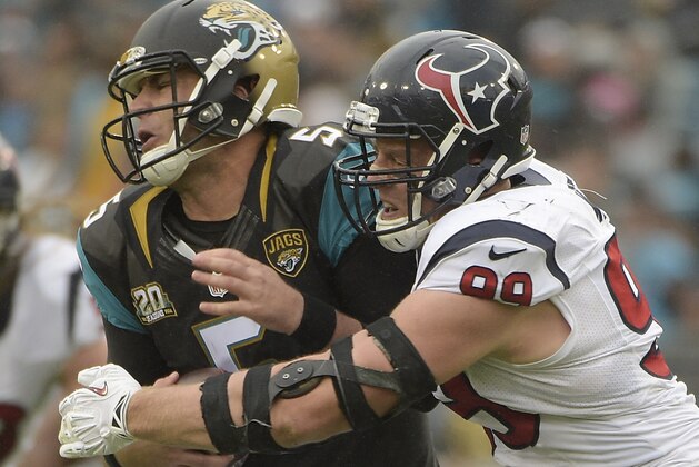 Jacksonville Jaguars quarterback Blake Bortles (5) is sacked by Houston Texans defensive end J.J. Watt (99) during the first half of an NFL football game in Jacksonville, Fla., Sunday, Dec. 7, 2014. (AP Photo/Phelan M. Ebenhack)