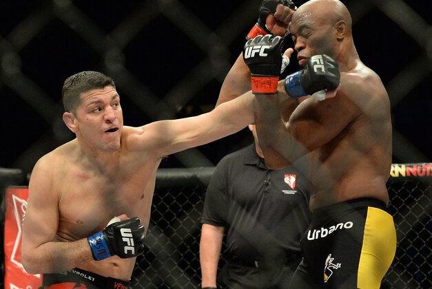 Jan 31, 2015; Las Vegas, NV, USA; Nick Diaz (blue gloves) punches at Anderson Silva (red gloves) during their middleweight bout during UFC 183 at the MGM Grand Garden Arena. Mandatory Credit: Jayne Kamin-Oncea-USA TODAY Sports