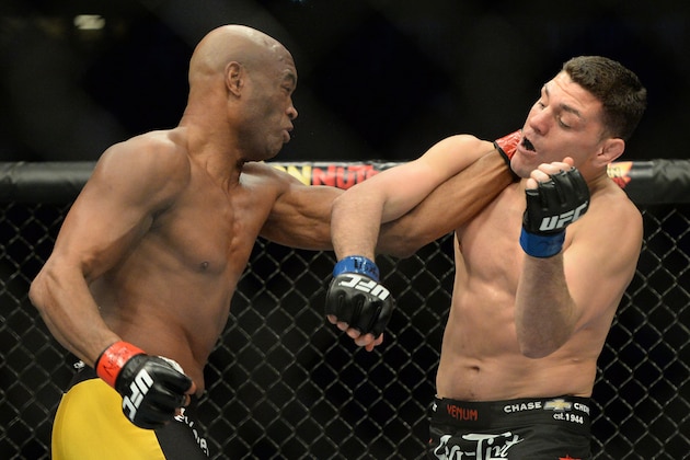 Jan 31, 2015; Las Vegas, NV, USA; Anderson Silva (red gloves) and Nick Diaz (blue gloves) fight during their middleweight bout during UFC 183 at the MGM Grand Garden Arena. Mandatory Credit: Jayne Kamin-Oncea-USA TODAY Sports