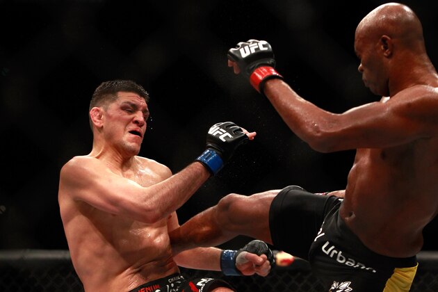 LAS VEGAS, NV - JANUARY 31:  Nick Diaz (L) takes a kick from Anderson Silva in a middleweight bout during UFC 183 at the MGM Grand Garden Arena on January 31, 2015 in Las Vegas, Nevada. Silva won by unanimous decision.  (Photo by Steve Marcus/Getty Images)