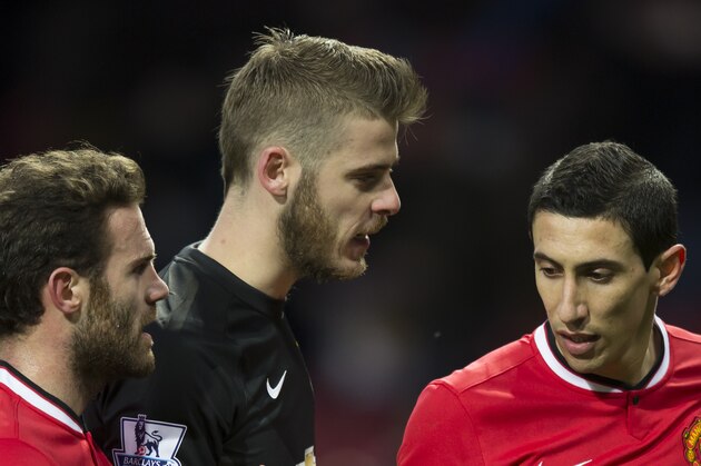 Manchester United's Angel Di Maria, right, congratulates teammates Juan Mata, left, and goalkeeper David De Gea after their 3-1 win during the English Premier League soccer match between Manchester United and Leicester at Old Trafford Stadium, Manchester, England, Saturday Jan. 31, 2015. (AP Photo/Jon Super)