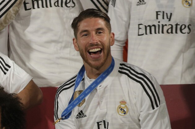 Real Madrid’s Sergio Ramos, who scored the team's first goal, poses with the trophy after winning the final soccer match between Real Madrid and San Lorenzo at the Club World Cup soccer tournament in Marrakech, Morocco, Saturday, Dec. 20, 2014. (AP Photo/Christophe Ena)