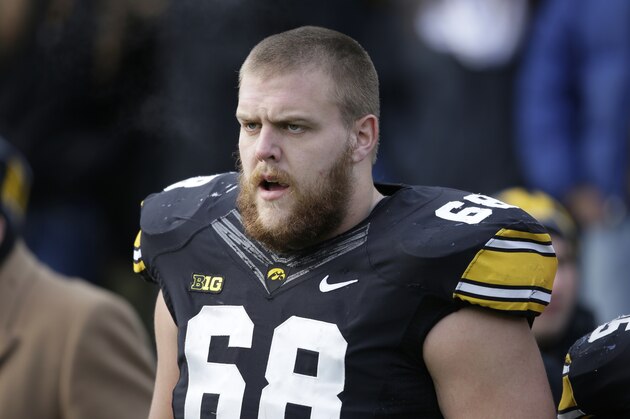 Iowa offensive lineman Brandon Scherff stands on the sidelines before an NCAA college football game against Nebraska, Friday, Nov. 28, 2014, in Iowa City, Iowa. (AP Photo/Charlie Neibergall)