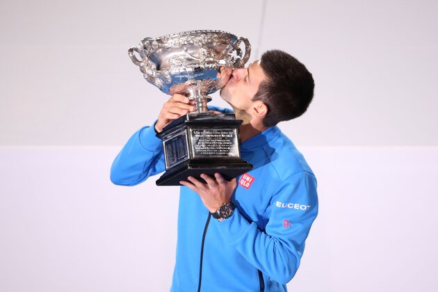 MELBOURNE, AUSTRALIA - FEBRUARY 01:  Novak Djokovic of Serbia holds the Norman Brookes Challenge Cup after winning his men's final match as Andy Murray of Great Britain looks on during day 14 of the 2015 Australian Open at Melbourne Park on February 1, 2015 in Melbourne, Australia.  (Photo by Michael Dodge/Getty Images)