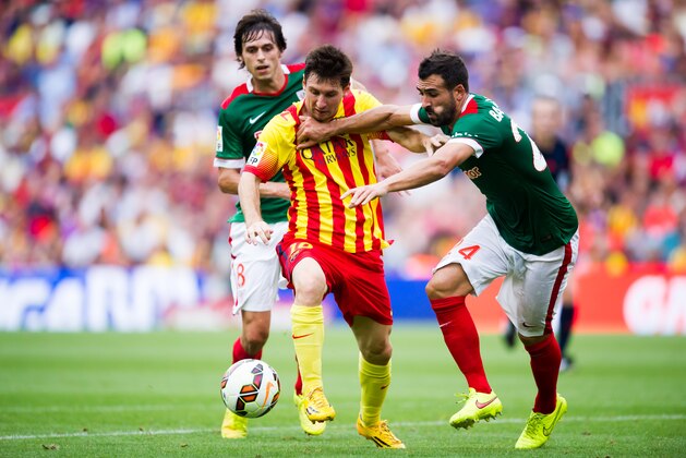 BARCELONA, SPAIN - SEPTEMBER 13: Lionel Messi (C) of FC Barcelona fights for the ball with Ander Iturraspe (L) and Mikel Balenziaga (R) of Athletic Club during the La Liga match between FC Barcelona and Athletic Club at Camp Nou on September 13, 2014 in Barcelona, Spain. (Photo by Alex Caparros/Getty Images)